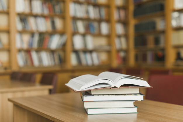 stack-of-books-on-library-desk_23-2147845946